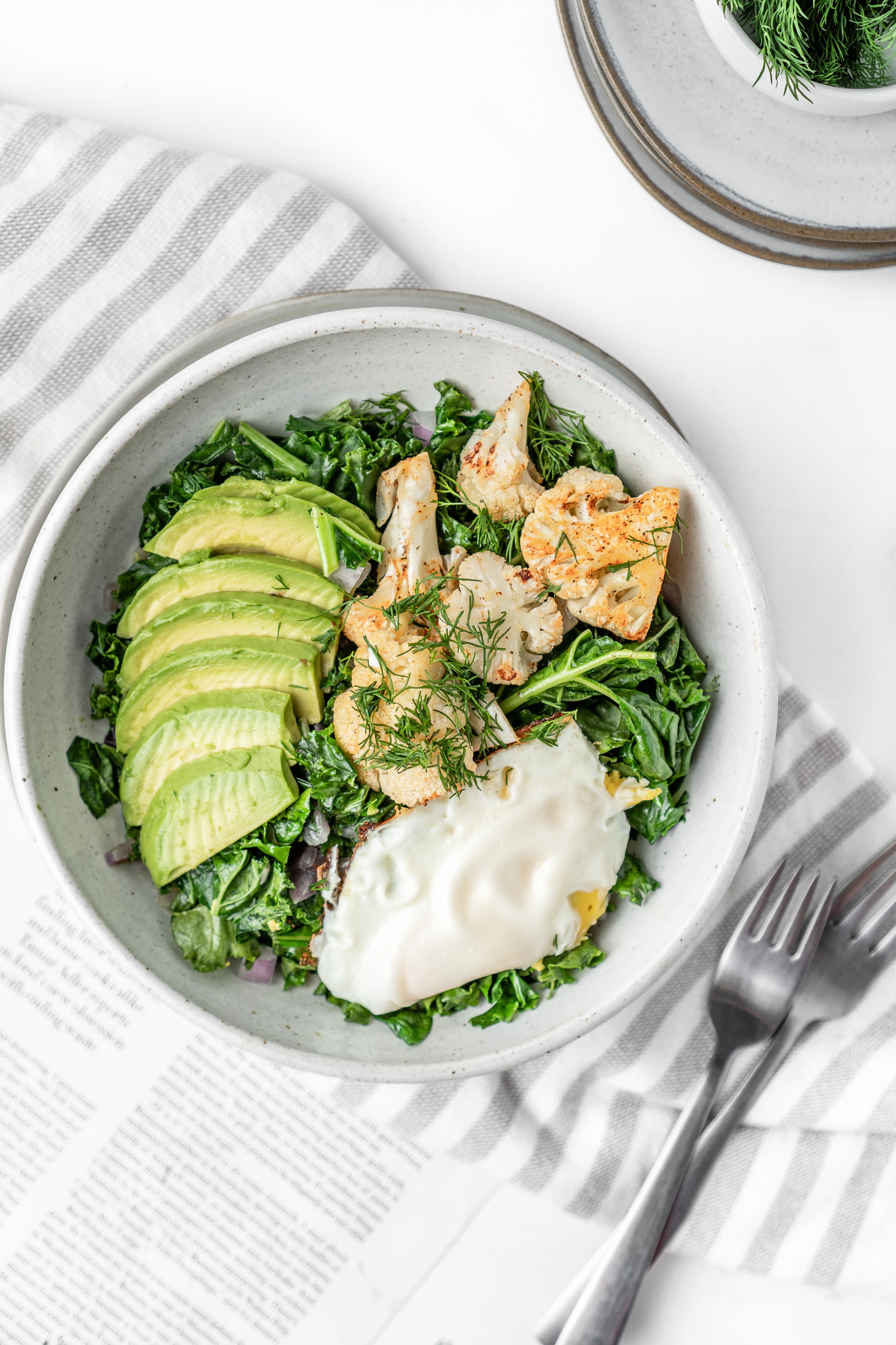 Top-down view of a fresh salad with fried egg — example of a balanced nutrition prescription.